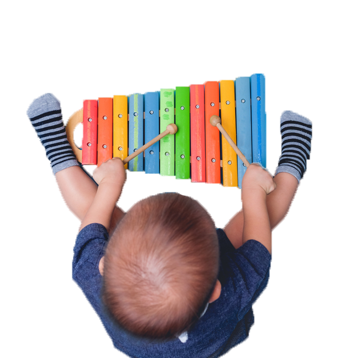 Toddler boy from above playing colourful xylophone