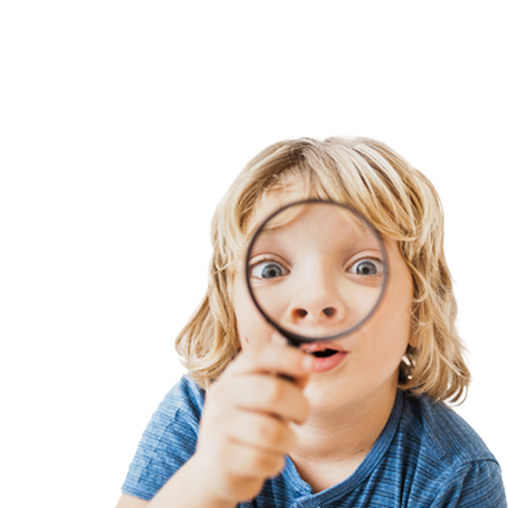Blond boy looking through magnifying glass