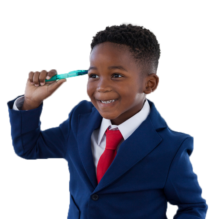 Young boy in business suit holding pen to head and smiling