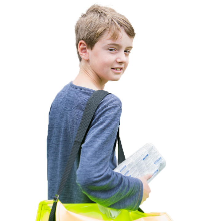 Teenage boy looking back holding a newspaper