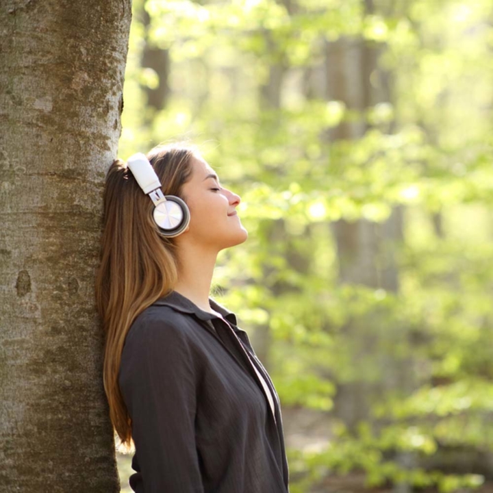 woman with headphones on in nature