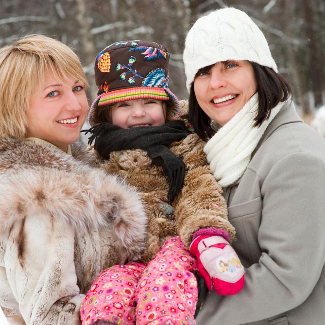 two mothers with child in winter wear